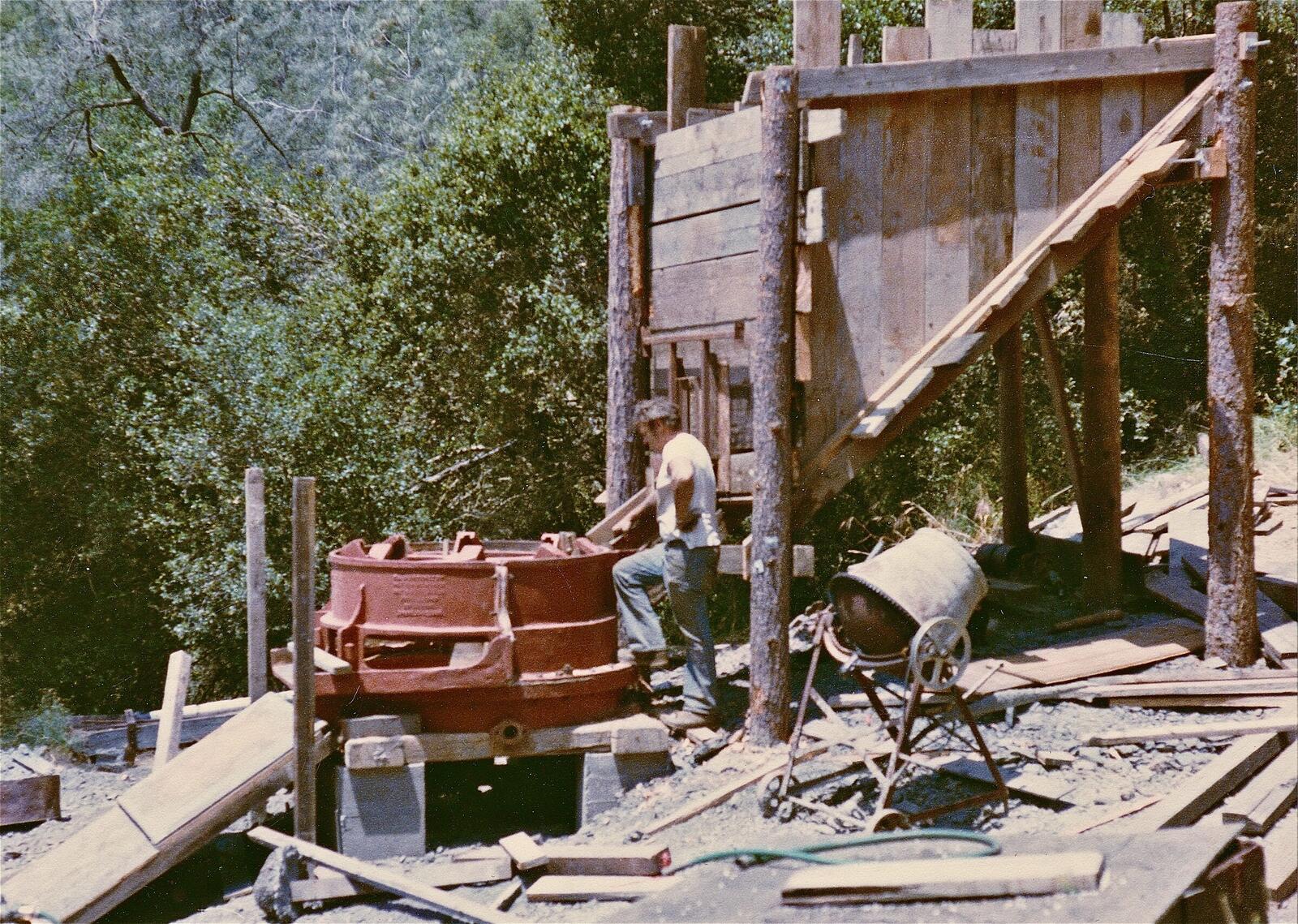 Gary, Don's father, at the red Huntington mill drum at the Red Wing in the 1980s, ore bin framework above.