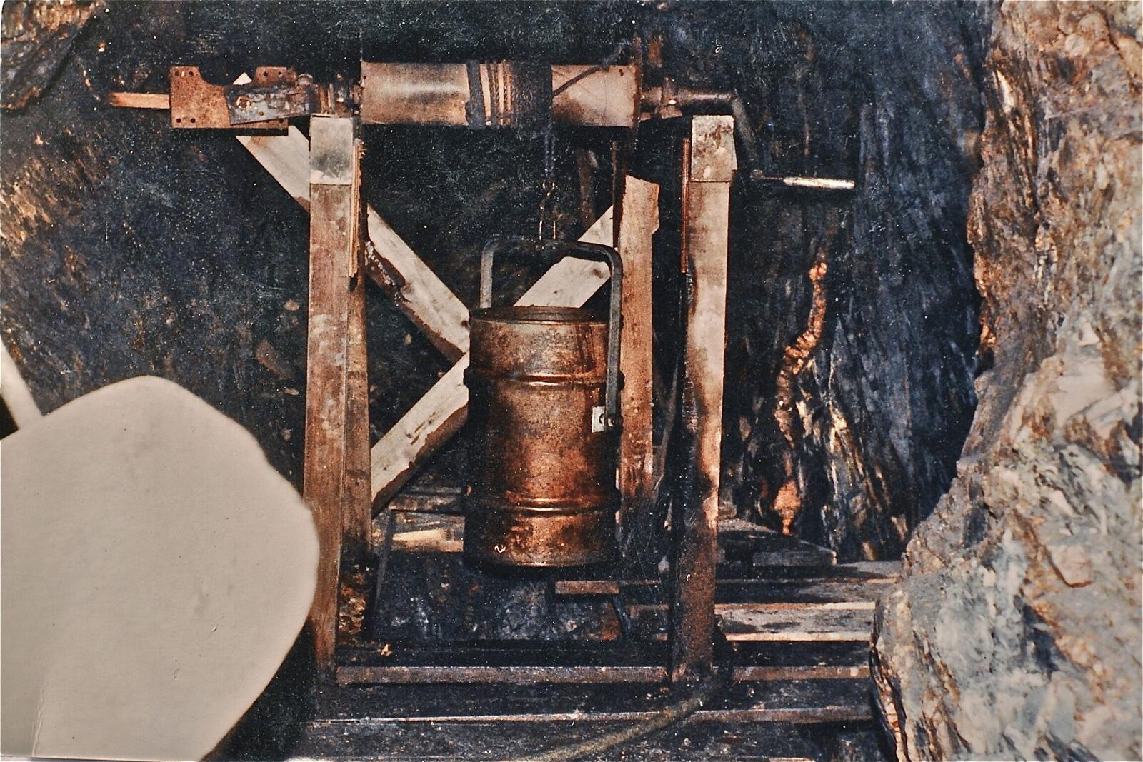 The wooden windlass and half-barrel bucket built above the stope in the Red Wing workings in the 1980s, used to lift ore out of the stope by hand-crank.