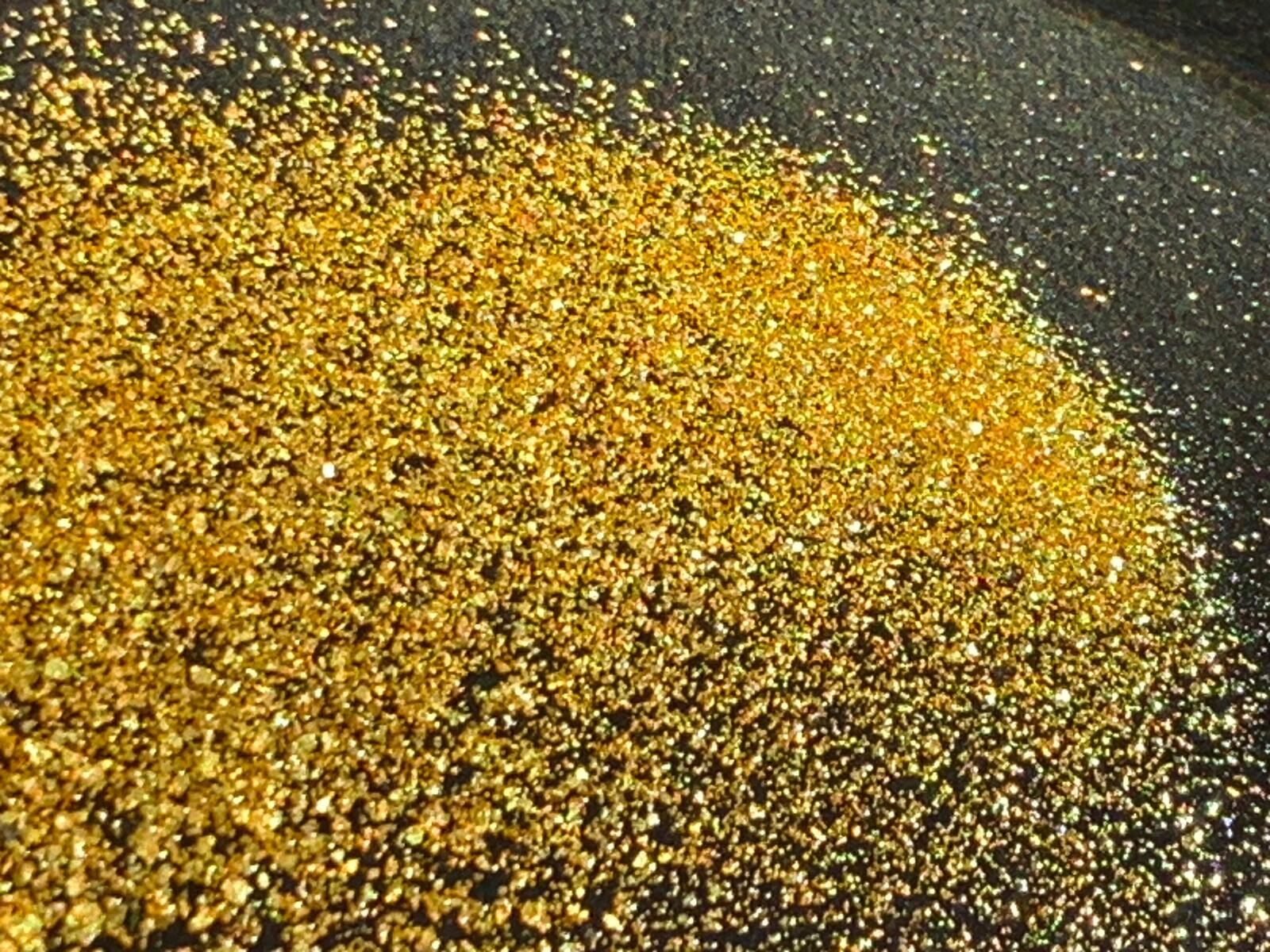 A heaped pile of clean coarse gold flakes after final cleanup, dry.