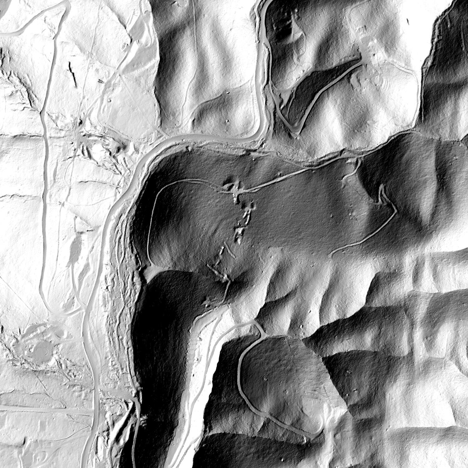 Bare-earth LiDAR multidirectional hillshade of the Red Wing Mine, showing the main worked hill, the central drainage, the access road wrapping the workings, and the dump lobes.