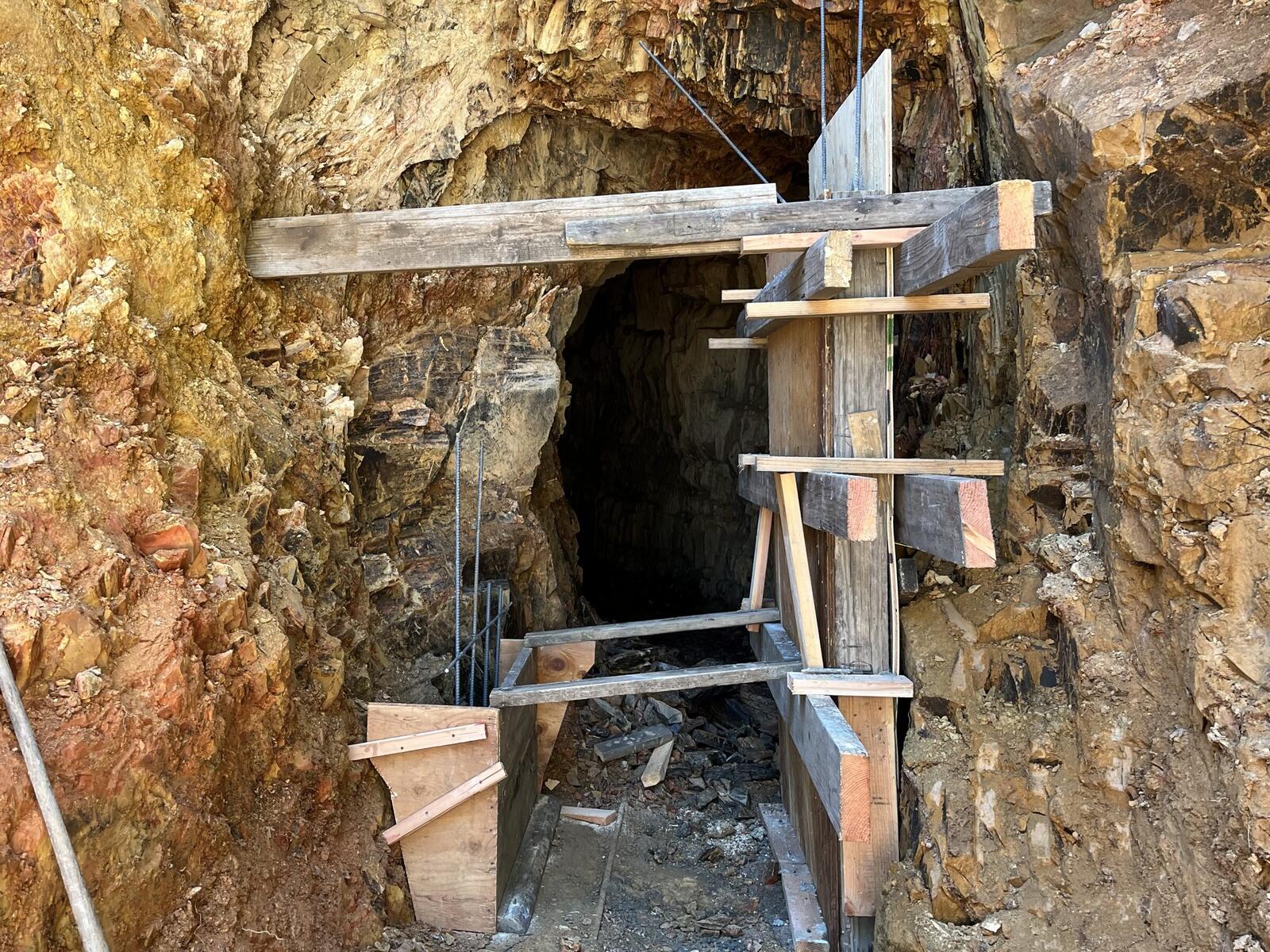 The wooden form for the new concrete portal Don is pouring at the Red Wing entry, with cap beam, cross-bracing, and plank floor in place.